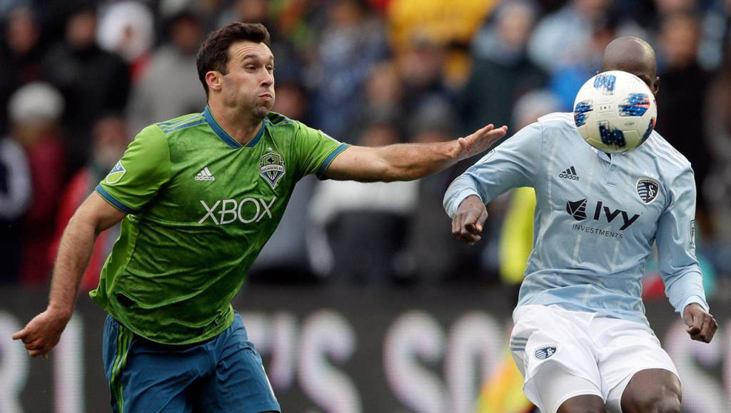 Seattle Sounders defender Will Bruin (left) tries to catch Sporting Kansas City defender Ike Opara during the first half of their MLS match Sunday in Kansas City, Kansas. (AP Photo/Orlin Wagner)