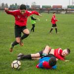 Gerardo Avalos-Ayala (left) hurdles over Cason Chadd (top) and Acxel Gonzalez-Lara (bottom) after the latter two players collided during a Snohomish Youth Soccer Club Development Academy scrimmage at Stocker Fields on April 5 in Snohomish. (Kevin Clark / The Daily Herald)