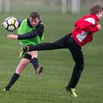 Alden Pate (left) kicks a ball while Gabriel Esterly defends during a Snohomish Youth Soccer Club Developement Academy scrimmage on April 5 at Stocker Fields in Snohomish. (Kevin Clark / The Herald)