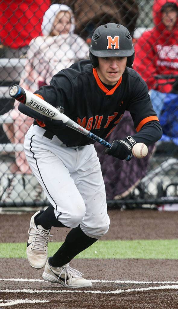 Monroes Kegan Velie lays down a bunt to advance a runner during a game against Cascade on April 17, 2018, in Monroe. (Andy Bronson / The Herald)