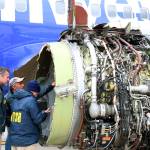 National Transportation Safety Board investigators examine damage to the engine of a Southwest Airlines Boeing 737 that made an emergency landing at Philadelphia International Airport on Tuesday. (NTSB via AP)
