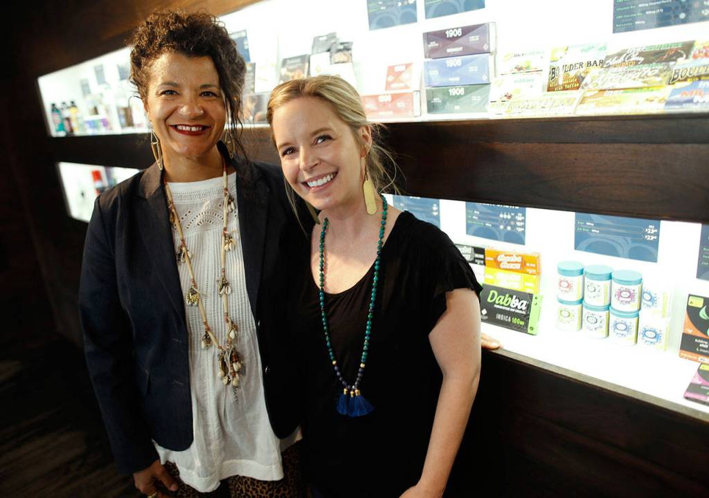 Kelly Perez (left), chief executive officer and founder of kindColorado, and Courtney Mathis, the organizations president and founder, pose inside a cannabis dispensary in east Denver on April 16. kindColorado provides community engagement opportunities for the cannabis industry to be assets in communities. (AP Photo/David Zalubowski)