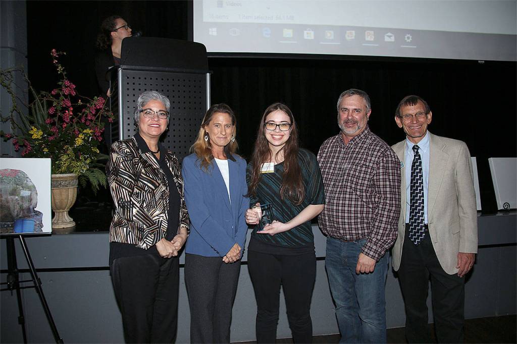 Emily McLaughlin Sta. Maria (center) receives a Youth Conservation Leader of the Year award. Hes pictured with, from left, Maia Bellon, Washington Department of Ecology director, Stephanie Wright, Snohomish County Council chair, Mark Craven, Snohomish Conservation District Board chair, and Monte Marti, SCD district manager. (Contributed photo)
