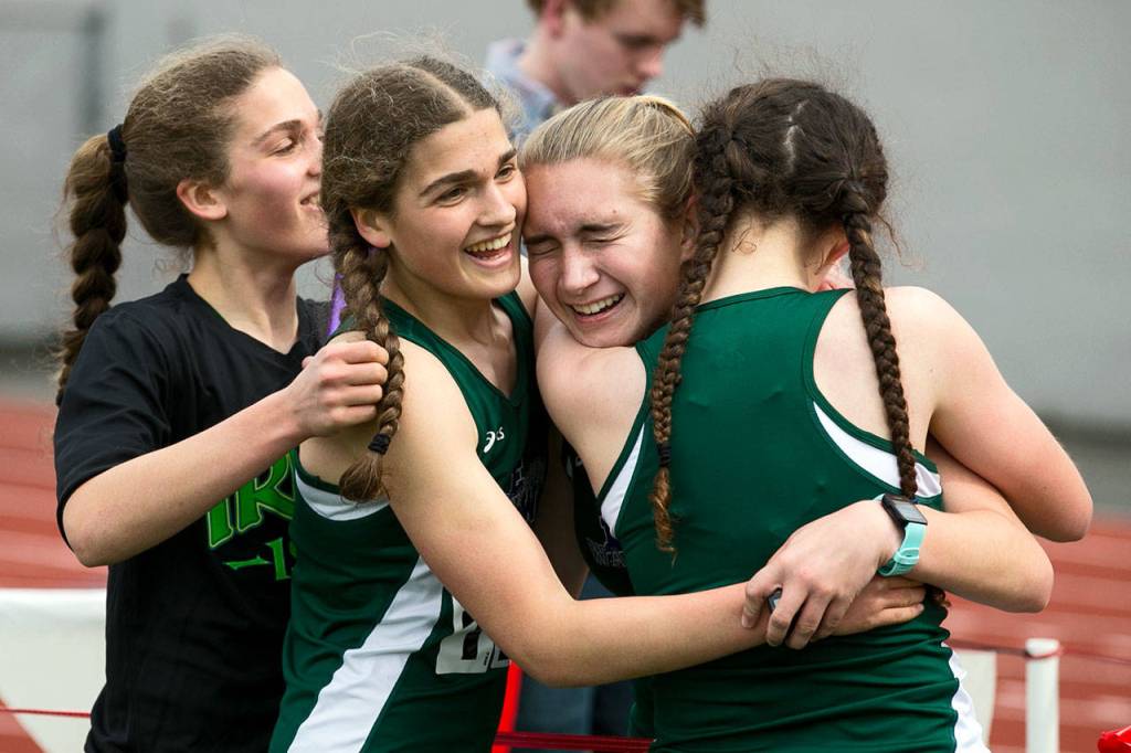 Edmonds-Woodways distance medley relay team celebrates their first-place finish at the annual Larry Eason Invitational on April 21, 2018, at Veterans Memorial Stadium in Snohomish. (Kevin Clark / The Herald)
