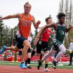 Eastside Catholics David Pritchard (left) leans to capture the win ahead of Edmond-Woodways Chinedu Acholonu in the 100-meters at the annual Larry Eason Invitational on April 21, 2018, at Veterans Memorial Stadium in Snohomish. (Kevin Clark / The Herald)