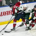 The Silvertips Sean Richards attempts to splits Tri-Citys Jake Bean (left) and Tri-Citys Michael Rasmussen during a playoff game on April 21, 2018, at Angel of the Winds Arena in Everett. (Kevin Clark / The Herald)
