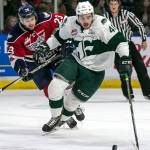 Everetts Garrett Pilon chases down the puck with Tri-Citys Isaac Johnson trailing at Angel of the Winds Arena on April 20. (Kevin Clark / The Daily Herald)
