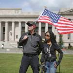 Daniel and Gina Powell, of Edmonds, listen to speakers as more than 1,000 people gathered at the state Capitol in Olympia on Saturday for the March for our Rights gun rights rally. Speakers opposed gun legislation proposed in the wake of recent school shootings and national gun violence. (Genna Martin / seattlepi.com via AP)