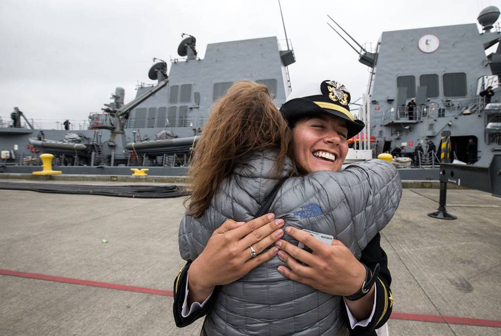 Lt. j.g. Cara Fisher hugs her host mom, Sally Hands, after the Navy destroyer USS Ralph Johnson arrived at Naval Station Everett on Friday. (Andy Bronson / The Herald)