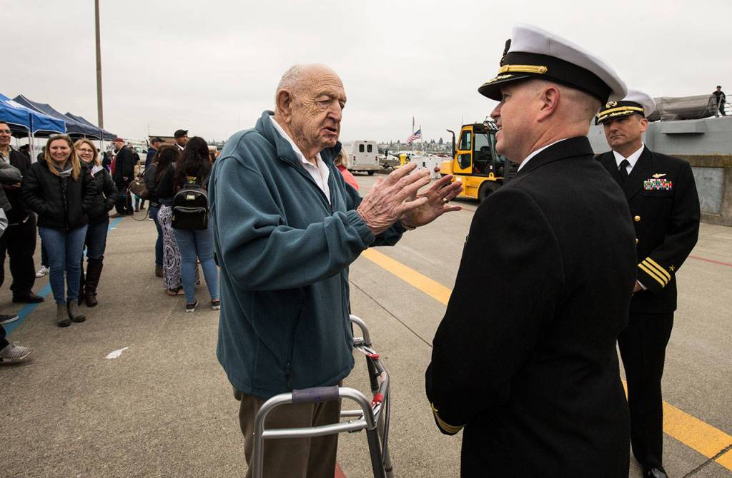 Chayne Stinemetz, 90, of Bothell, talks with Cmdr. Jason Patterson after the Navy destroyer USS Ralph Johnson arrived at Naval Station Everett on Friday. The ship was named for Pfc. Ralph Henry Johnson, a Marine who died in 1968 during the Vietnam War. Stinemetz was the commanding officer of the battalion in which Johnson served. (Andy Bronson / The Herald)