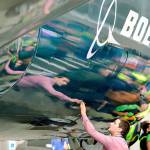 Boeing worker Paul Covaci reaches out to touch a Boeing 737 MAX 7, the newest version of Boeings fastest-selling airplane, on Feb. 5 during an unveiling for employees and media in Renton. (AP Photo/Elaine Thompson, File)