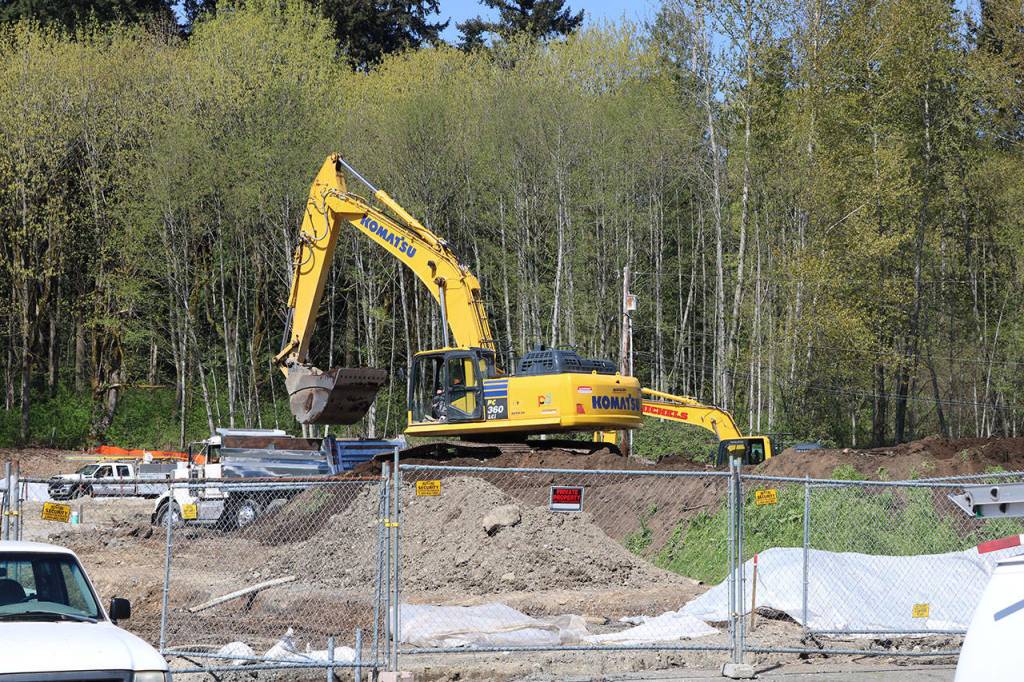Country Village sat on 13 acres in north Bothell, but around six acres were sold to developers who are building more than 90 townhomes on the land. An excavator crew is pictured at work here on a recent afternoon. (Aaron Kunkler / Bothell-Kenmore Reporter)