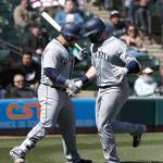 Seattles Mike Zunino (right) greets teammate Daniel Vogelbach at home plate after Zunino hit a home run during the sixth inning of Wednesdays game in Chicago. (AP Photo/Charles Rex Arbogast)