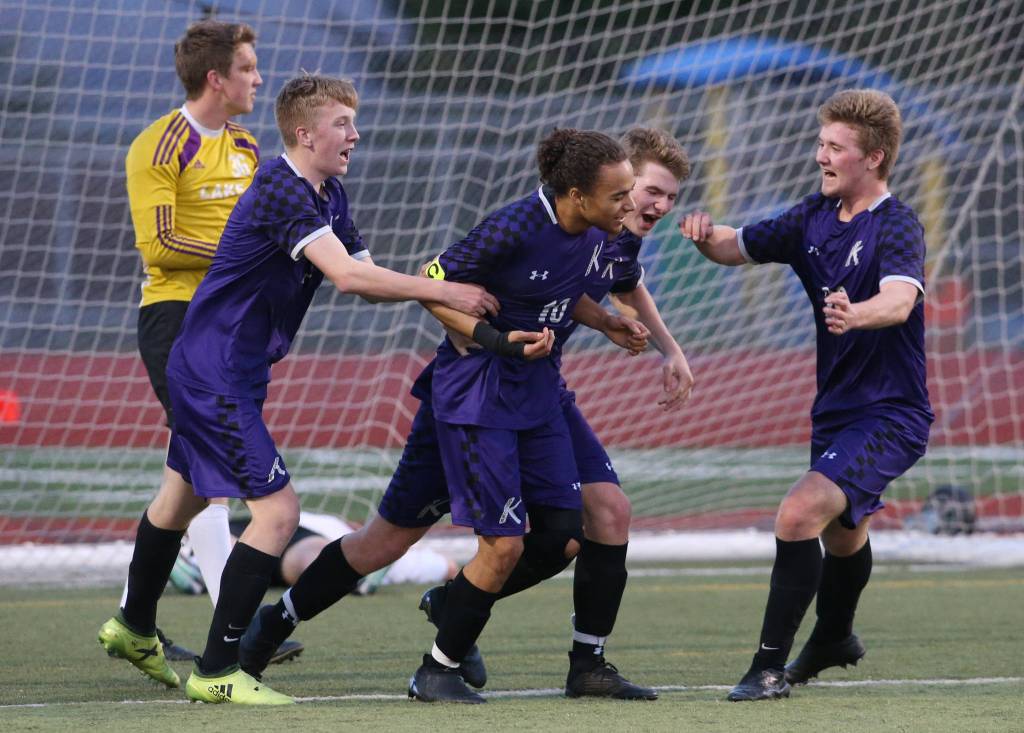 Kamiak players surround Andre Hamilton (10) after his goal against Lake Stevens on Tuesday, April 24, 2018 in Lake Stevens, Wa. (Andy Bronson / The Herald)