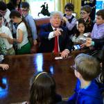 President Donald Trump is surrounded by kids in the Oval Office in celebration of Bring Our Daughters and Sons to Work Day at the White House in Washington on Thursday. (AP Photo/Manuel Balce Ceneta)