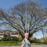 Lya Badgely stands near a Chinese Chestnut tree on the corner of Fifth Street and Avenue B in Snohomish. Badgley and other volunteers will be leading tours of notable trees and homes in the historic district on Mothers Day, May 13. (Andy Bronson / The Herald)