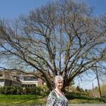 Lya Badgely stands near a Chinese Chestnut tree on the corner of Fifth Street and Avenue B in Snohomish. Badgley and other volunteers will be leading tours of notable trees and homes in the historic district on Mothers Day, May 13. (Andy Bronson / The Herald)