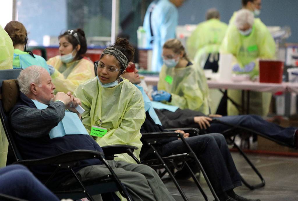 Aracely Cortez, a dental student from Carnation, listens to a patient at the AMEN Clinic. (Photo by Heidi Baumgartner)