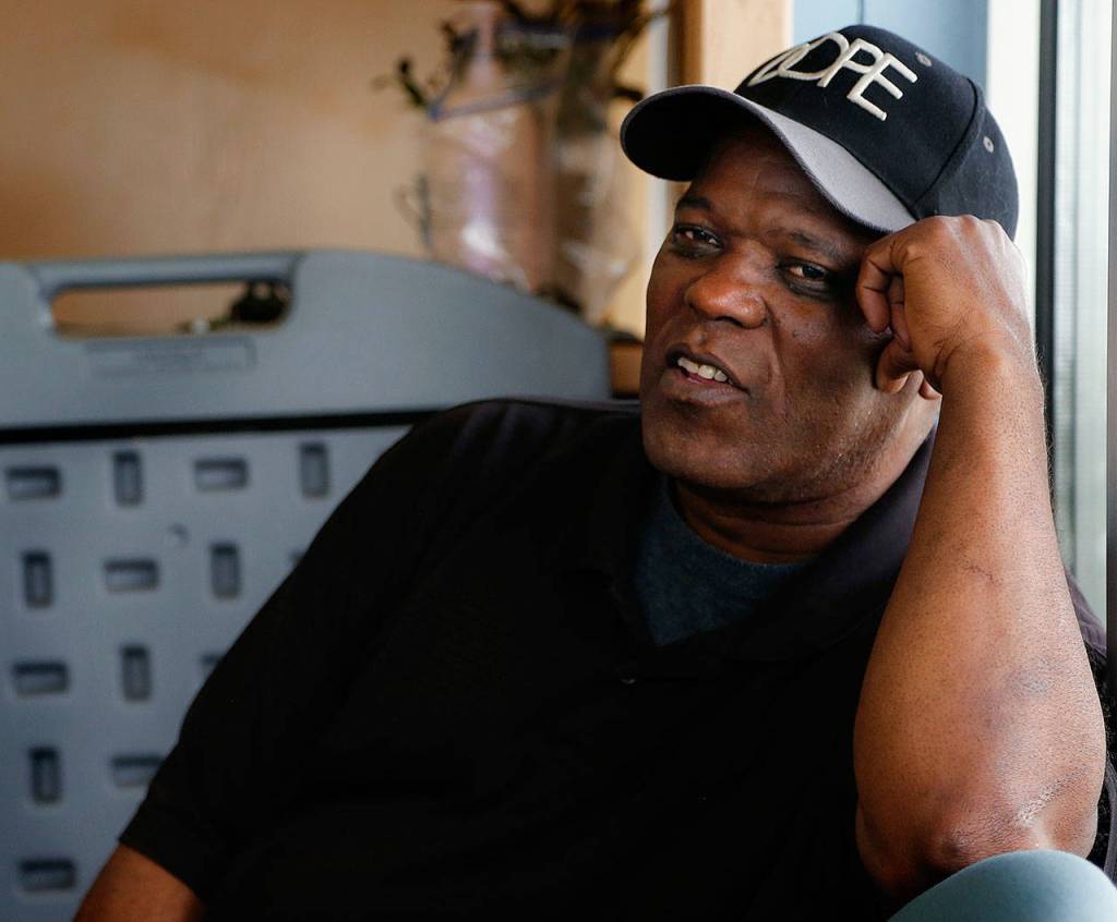 Samuel Williford, 63, waits in the lobby for the Everett Food Bank to open Wednesday in the Volunteers of America building. Williford works part time as a cook, but because his rent has nearly tripled in recent years, he finds himself depending on the food bank. (Dan Bates / The Herald)
