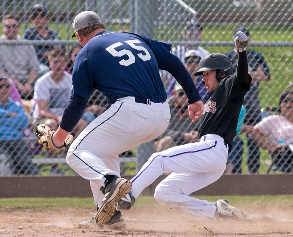 Lake Stevens Bryce Mefford (right) scores a run with Glacier Peak pitcher Noah Stingily closing in to try and make the tag during a loser-out 4A district playoff game on May 5, 2018, at Glacier Peak High School in Snohomish. (Kevin Clark / The Herald)