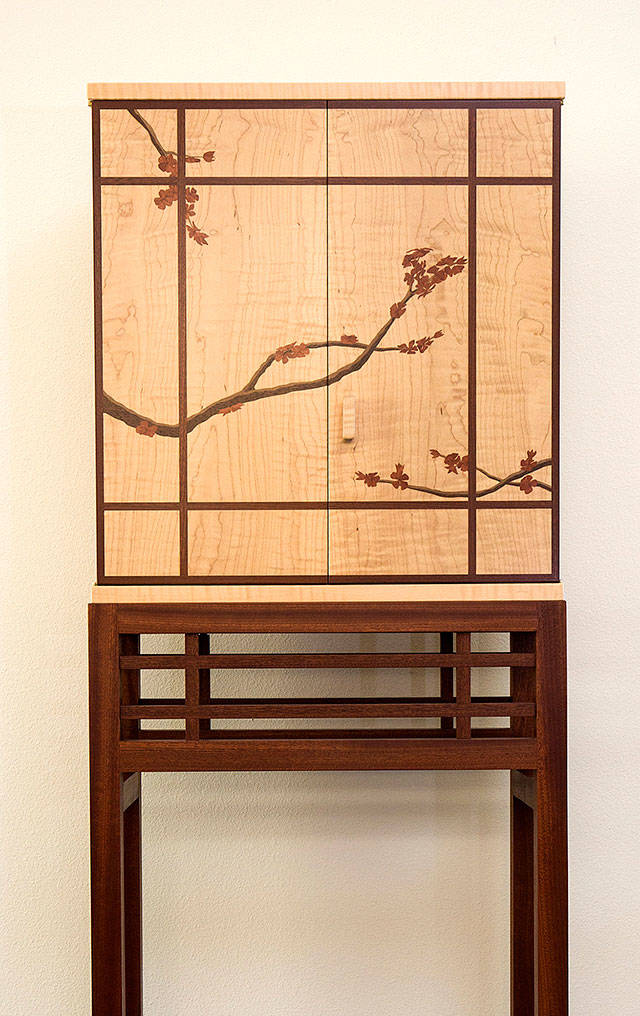 This cabinet with marquetry by Russ Riddle was made from curly maple, African sapele, walnut and African pink ivory wood. (Andy Bronson / The Herald)