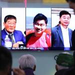 In this May 3 photo, people watch a TV news report on screen showing portraits of three Americans, Kim Dong Chul (left), Tony Kim and Kim Hak Song (right), detained in North Korea, at the Seoul Railway Station in Seoul, South Korea. (AP Photo/Ahn Young-joon)