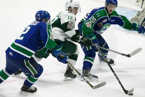 Swift Currents Colby Sissons (left) and Swift Currents Aleksi Heponiemi defend against Silvertips Matt Fonteyne in the first period Wednesday night at Angel of the Winds Arena in Everett on May 9, 2018.. (Kevin Clark / The Herald)