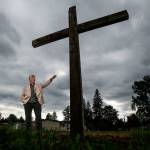 Standing on the marked ground where a new church will be built, Rev. Jay DeFolco of Holy Cross Catholic Church of Lake Stevens and Granite Falls talks about the parish, which will break ground here on Sunday. (Dan Bates / The Herald)