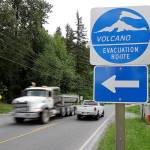 A volcano evacuation route sign directs traffic and pedestrians to an area of higher ground near Orting, on Tuesday. (AP Photo/Ted Warren)
