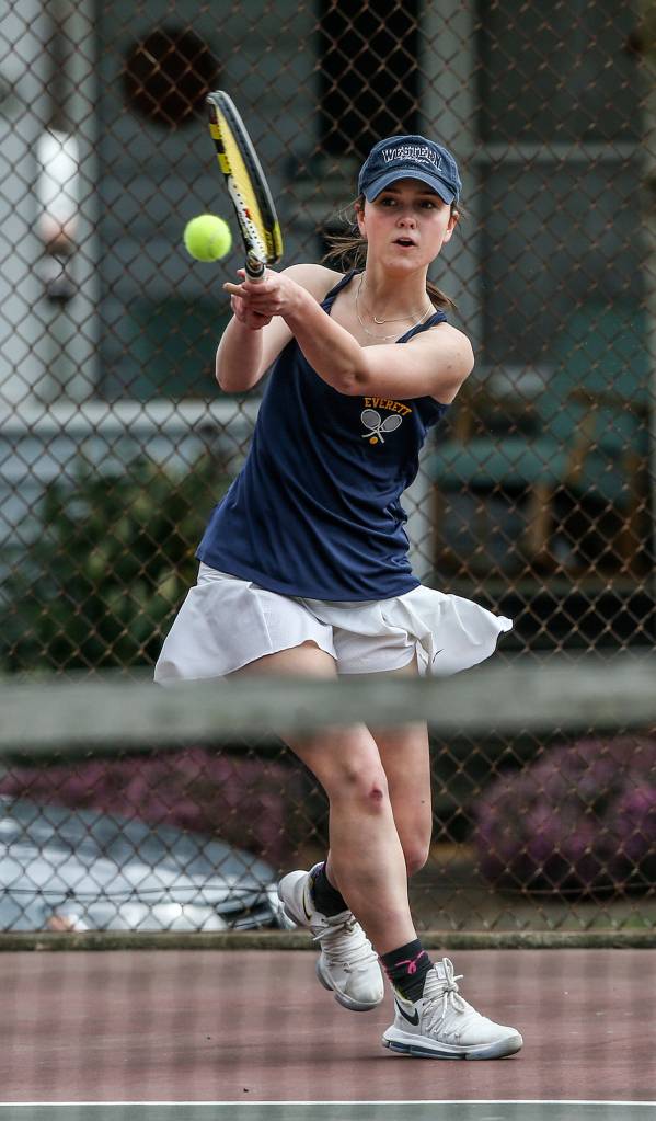 Abby Affholter backhands a shot against a Stanwood opponent on April 30 in Everett. (Andy Bronson / The Herald)