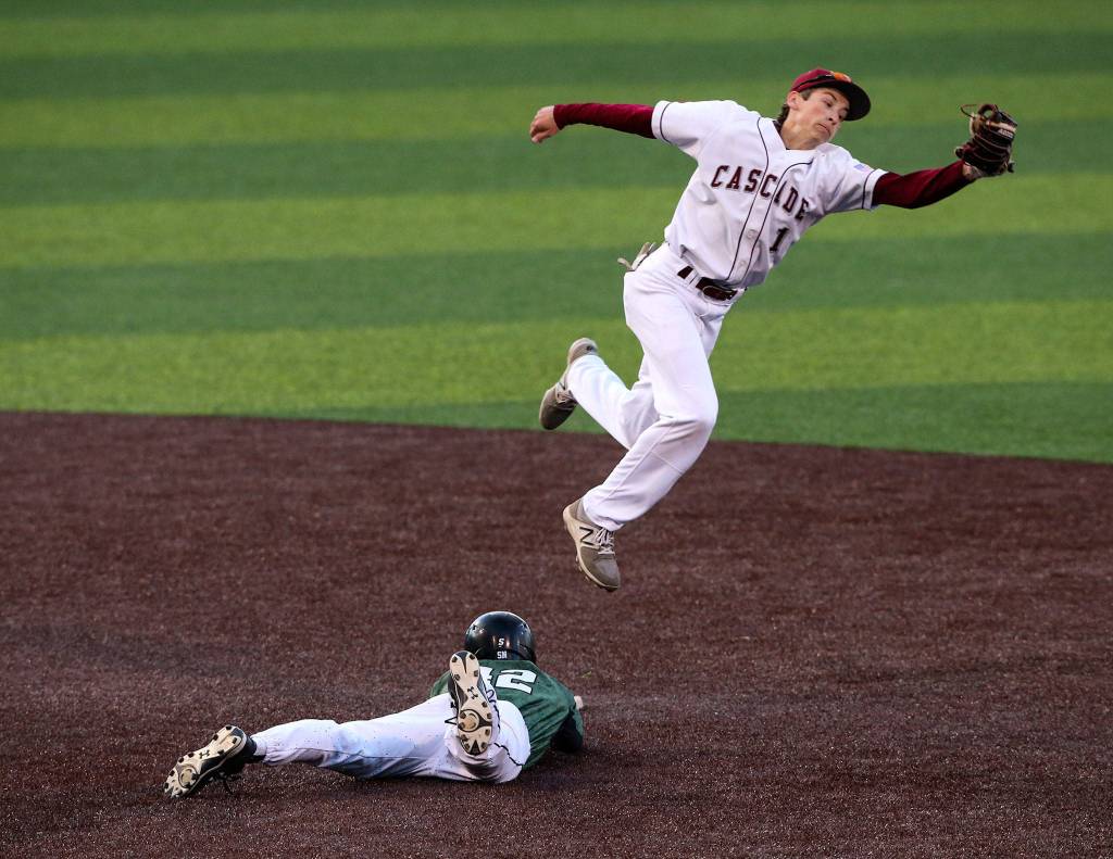 Leaping for a throw to second, Cascades Benjamin Hansen sails over Jacksons Chase Mathews. Jackson beat Cascade 3-0 to take the 4A district championship at Everett Memorial Stadium on May 10 in Everett. (Andy Bronson / The Herald)