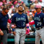 Robinson Cano of the Seattle Mariners (22) grimaces while being attended to by trainer Rob Nodine (left) and manager Scott Servais after being hit in the hand by a pitch from Detroits Blaine Hardy in the third inning of Sundays game in Detroit. (AP Photo/Paul Sancya)