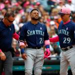 Paul Sancya / Associated Press                                Robinson Cano of the Seattle Mariners (22) grimaces while being attended to by trainer Rob Nodine (left) and manager Scott Servais after being hit in the hand by a pitch from Detroits Blaine Hardy in the third inning of Sundays game in Detroit.