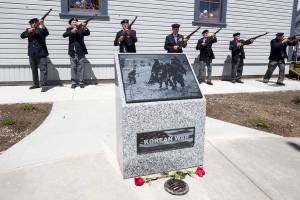 a 21-gun salute is fired at the end of the Memorial Day dedication of the Stanwood Area Historical Society Community Veterans Memorial at the Floyd Norgaard Cultural Center on Monday, May 28, 2018 in Stanwood, Wa. (Andy Bronson / The Herald)