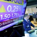 Specialist Edward Loggie works at his post on the floor of the New York Stock Exchange as the rate decision of the Federal Reserve is announced on March 21. (AP Photo/Richard Drew, File)