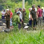 Rescue and search workers on the site where a Cuban airliner with more than 100 passengers on board plummeted into a yuca field just after takeoff from the international airport in Havana, Cuba, on Friday. (AP Photo/Ramon Espinosa)