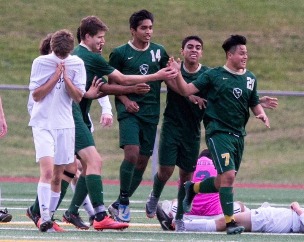 Redmond players celebrates a goal by Angel Hernandez (right) as Snohomish player walk away during a state quarterfinal match on May 18, 2018, at Veterans Memorial Stadium in Snohomish. (Kevin Clark / The Herald)