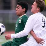 Redmonds Victor Araujo (left) fends off Snohomishs Owen Fieldler in the quarterfinals Friday night at Veterans Memorial Stadiums in Snohomish on May 18, 2018. (Kevin Clark / The Herald)