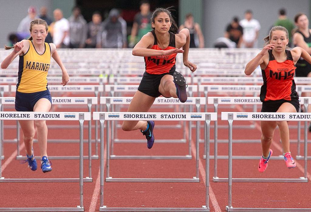 Monroes Hannah Ganashamoorthy (center) finishes first in the 100-meter hurdles during the 4A/3A District 1 track and field championships Friday at Shoreline Stadium. (Kevin Clark / The Herald)