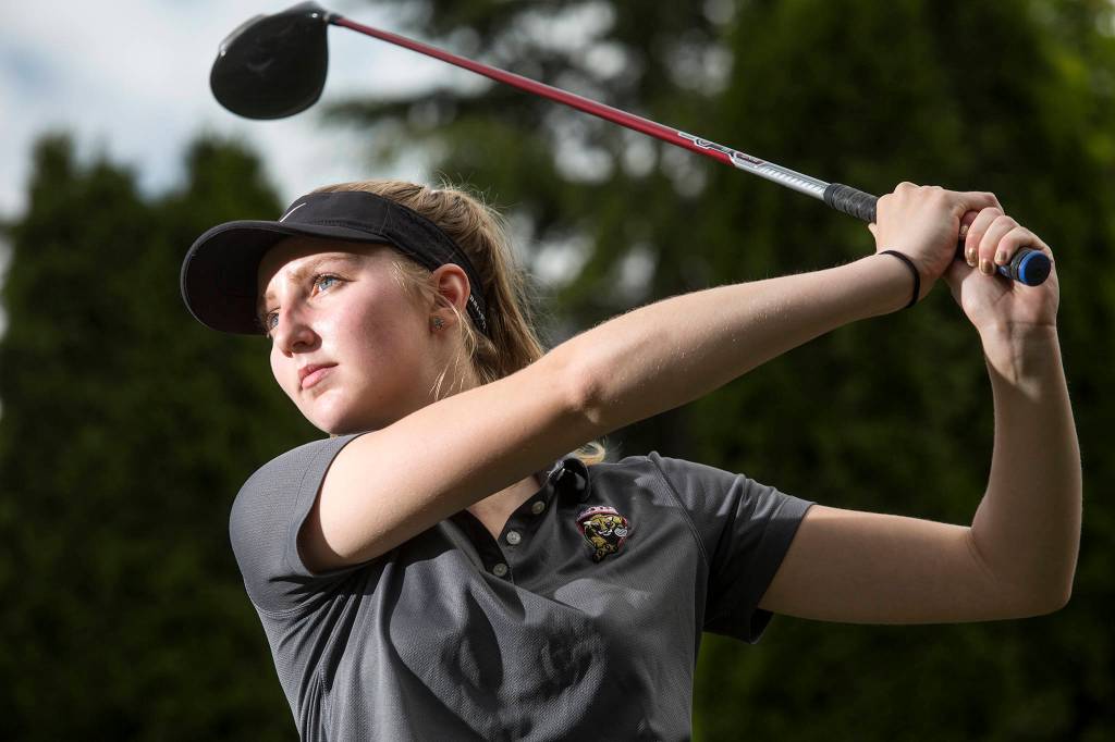 Lakewood senior golfer Bailey Dixon takes a swing at Gleneagles Golf Course on May 8 in Arlington. (Andy Bronson / The Herald)
