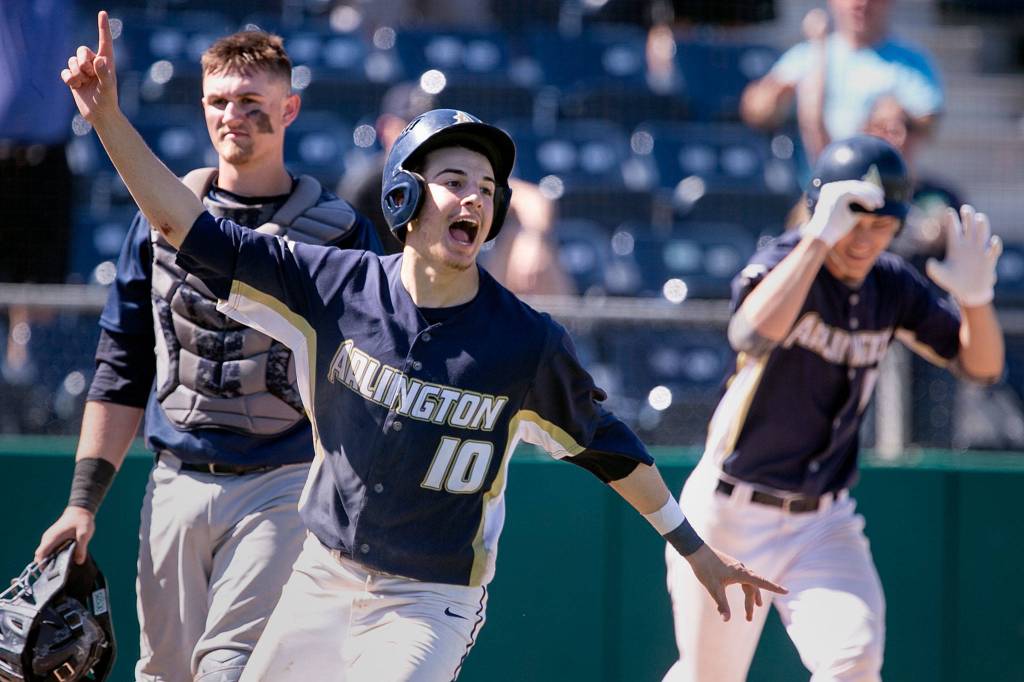 Arlingtons Nicholas Ferreira celebrates his winning run off Gavin Yorks RBI in 9 innings during the 3A district third-place game at Everett Memorial Stadium on May 12. (Kevin Clark / The Herald)