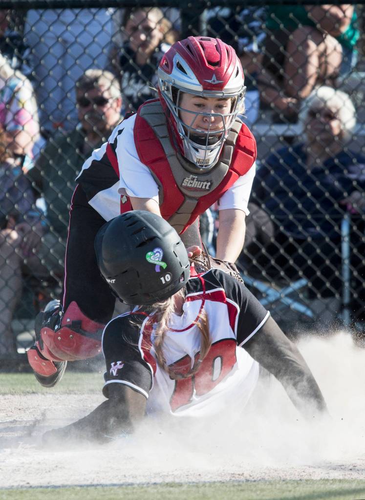 Snohomishs Joy Winston (10) slides safely under the tag of Marysville Pilchucks Sydney Zachry as Snohomish beat Marysville-Pilchuck 8-6 in a 3A softball district semifinal fastpitch game at Phil Johnson Ballfields on May 15 in Everett. (Andy Bronson / The Herald)