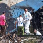 Forensic investigators and Ministry of Interior officers sift through the remains of a Boeing 737 that plummeted into a yuca field with more than 100 passengers on board, in Havana, Cuba, on Friday. (AP Photo/Desmond Boylan)