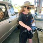 Kerri Clark, of Everett, under the watchful eye of her terrier, Chewie, fills up her Ford pickup for her Memorial Day weekend fun at Blackmans Lake in Snohomish to do some fishing. Regular gas at Forest Park Chevron at Rucker Avenue and 41st Street was going for $3.49 a gallon Wednesday. She wanted to fill up early to beat the lines and any rise in gas prices. (Andrea Brown / The Herald)
