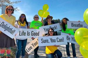 Mill Creek women ‘sprinkle’ happiness for passing motorists