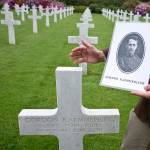 Superintendent of the Aisne Marne Cemetery, Shane Williams, holds a photo of World War I soldier Lt. Gordon Kaemmerling as he stands in front of his headstone at the World War I Aisne Marne cemetery in Belleau, France on Wednesday. The World War I battle of Belleau Wood in northern France pitted untested U.S. forces against the more-experienced Germans, who were making a push toward Paris. It became a defining moment, proving the Americans military mettle and helping turn the tide of the war. (AP Photo/Virginia Mayo)