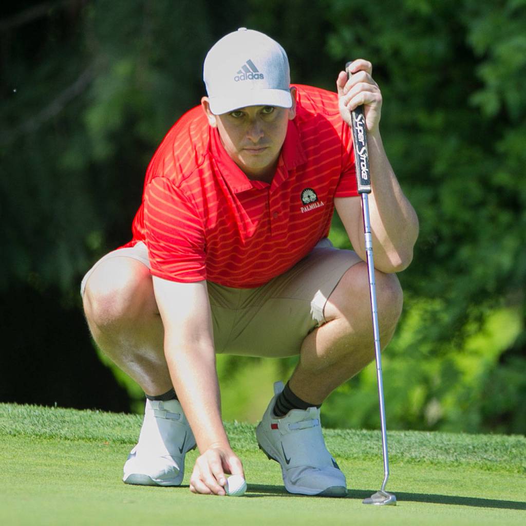 Joel Micka lines up a putt Sunday morning in the second day of the 2018 Snohomish County Amateur golf tournament at Harbour Pointe Golf Course in Mukilteo on May 27, 2018. (Kevin Clark / The Herald)