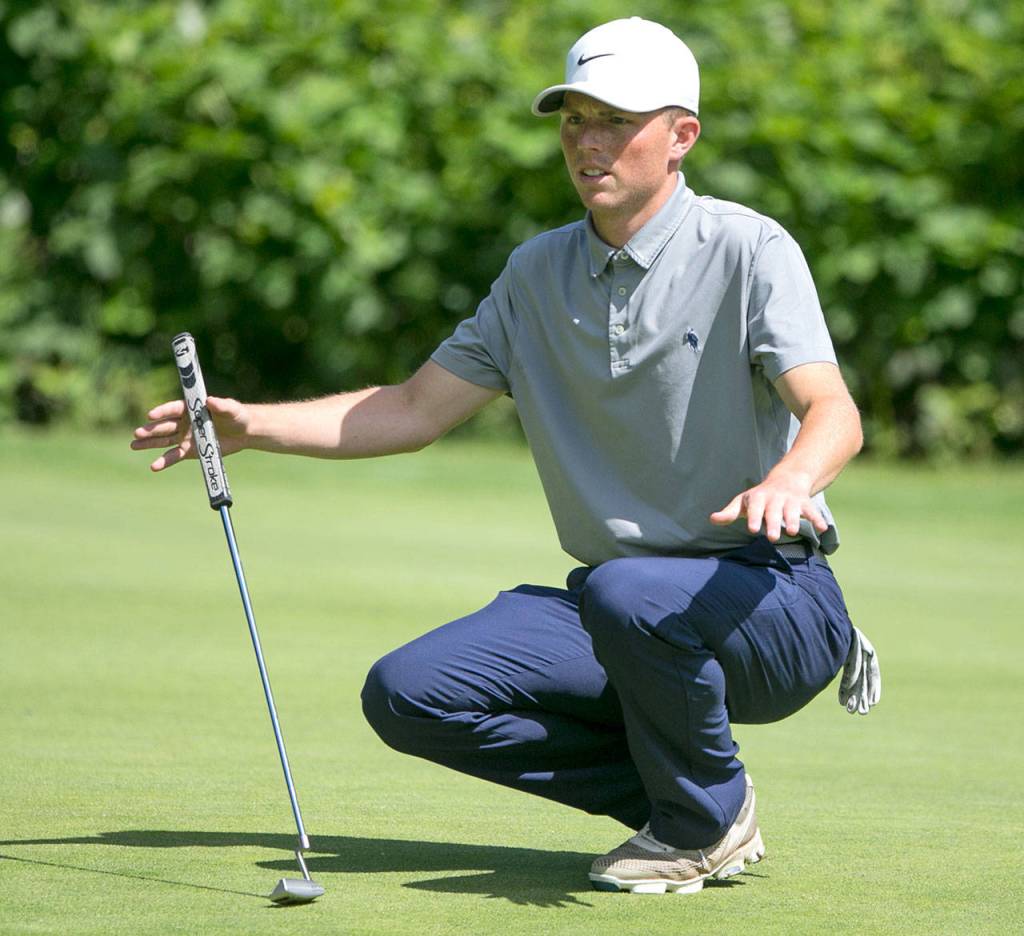 David Hansen examines the roll of the green on the second day of the 2018 Snohomish County Amateur golf tournament on May 27, 2018, at Harbour Pointe Golf Course in Mukilteo. (Kevin Clark / The Herald)