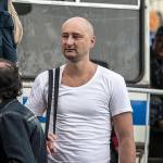 In this 2013 photo, Arkady Babchenko, 41, who had been scathingly critical of the Kremlin in recent years, stands at a police bus during an opposition rally in Moscow, Russia. (AP Photo/Alexander Baroshin)
