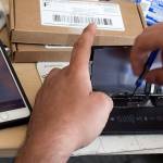 Amir Sultan repairs a phone in a dorm room at the University of Washington in Seattle. (Kevin Clark / The Herald)